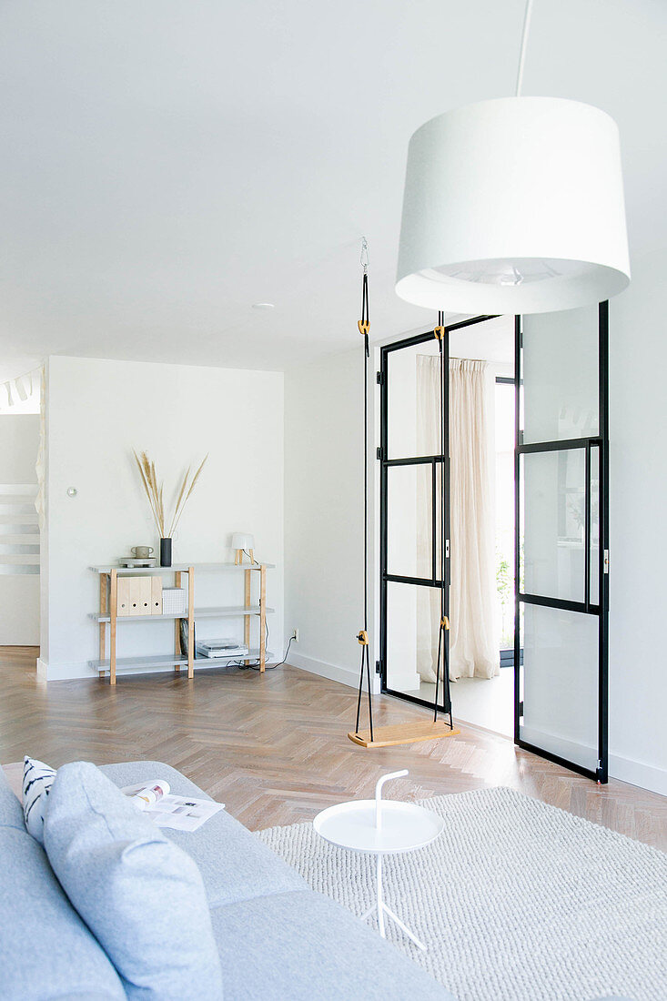 Swing and glass-and-steel door in minimalist living room