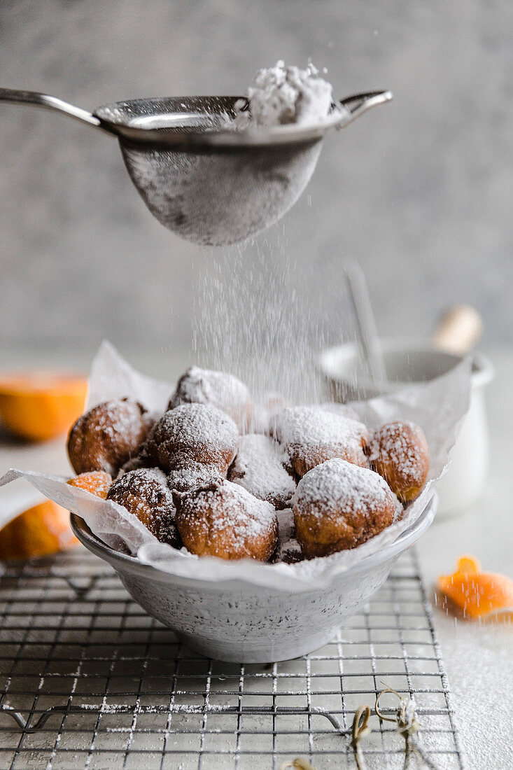 Cara cara fritters, with chocolate dipping sauce and powdered sugar