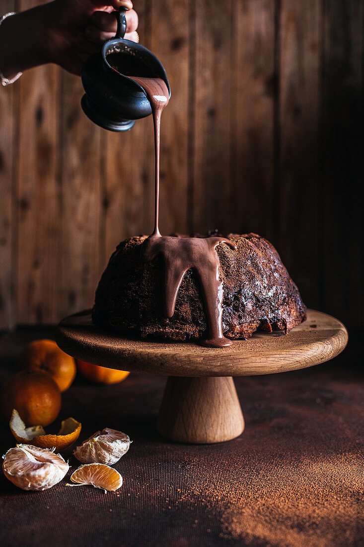 Bread and butter pudding with chocolate sauce and mandarins