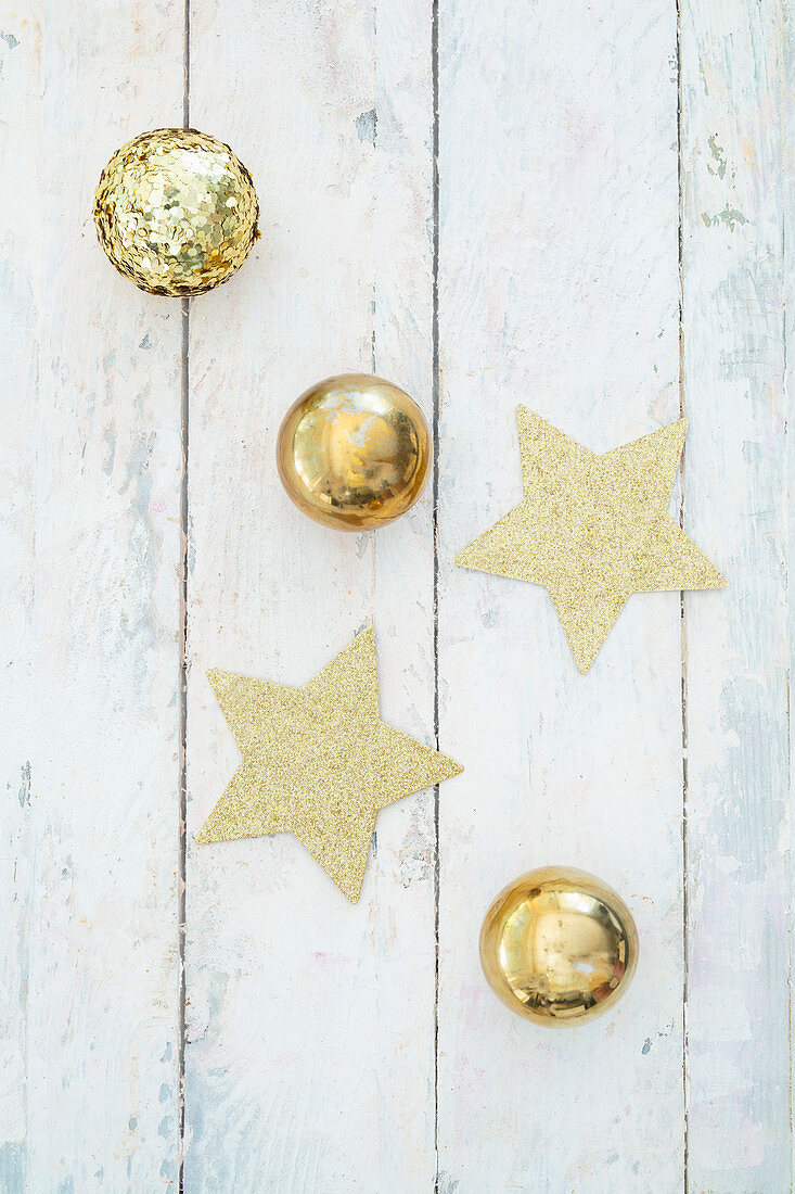 Stars and gold balls on festive surfacee