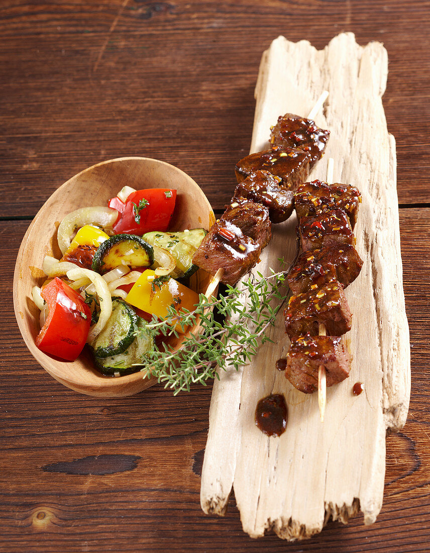 Oriental marinated grilled beef kebabs with grilled vegetables