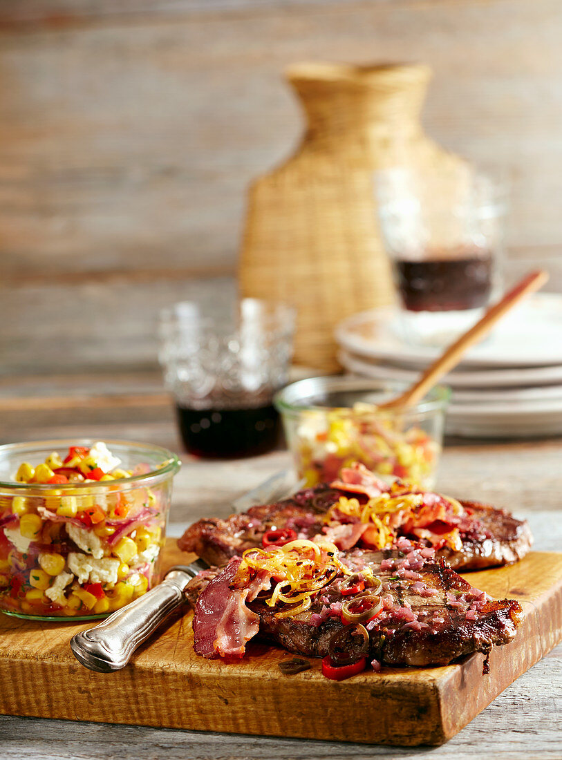 Grilled beef steak with bacon, onions and corn salad with cheese (Mexico)