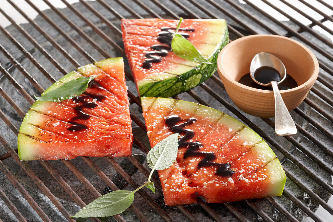 Sliced grilled watermelon with balsamic cream and pineapple sage