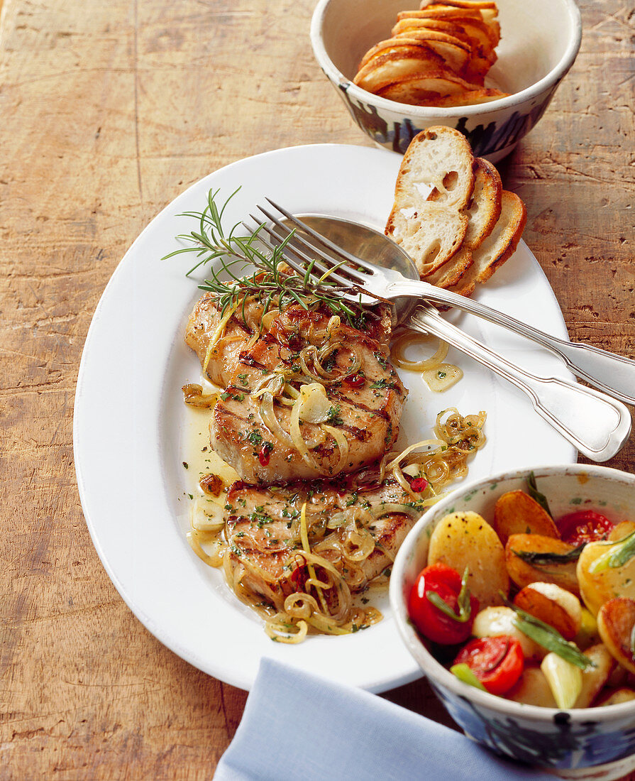 Grilled steaks with onions and rosemary