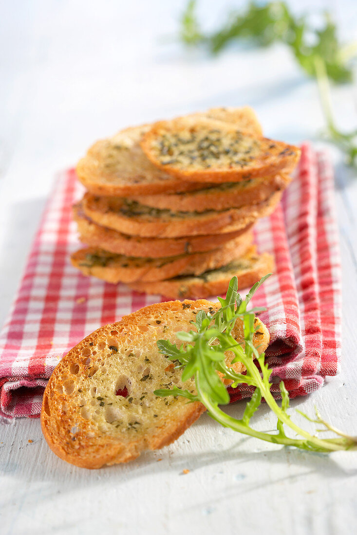 Gegrillte Baguette-Chips mit Rucolabutter auf Serviette