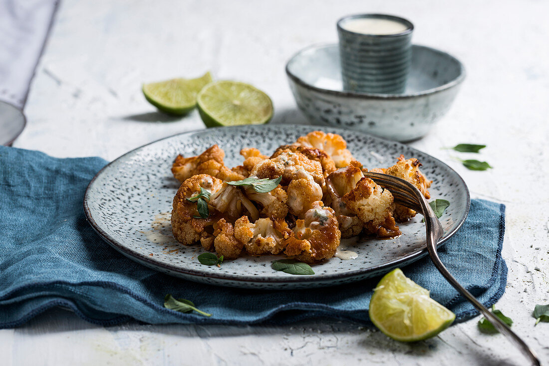 Spicy marinated, oven-baked cauliflower with a herb sauce