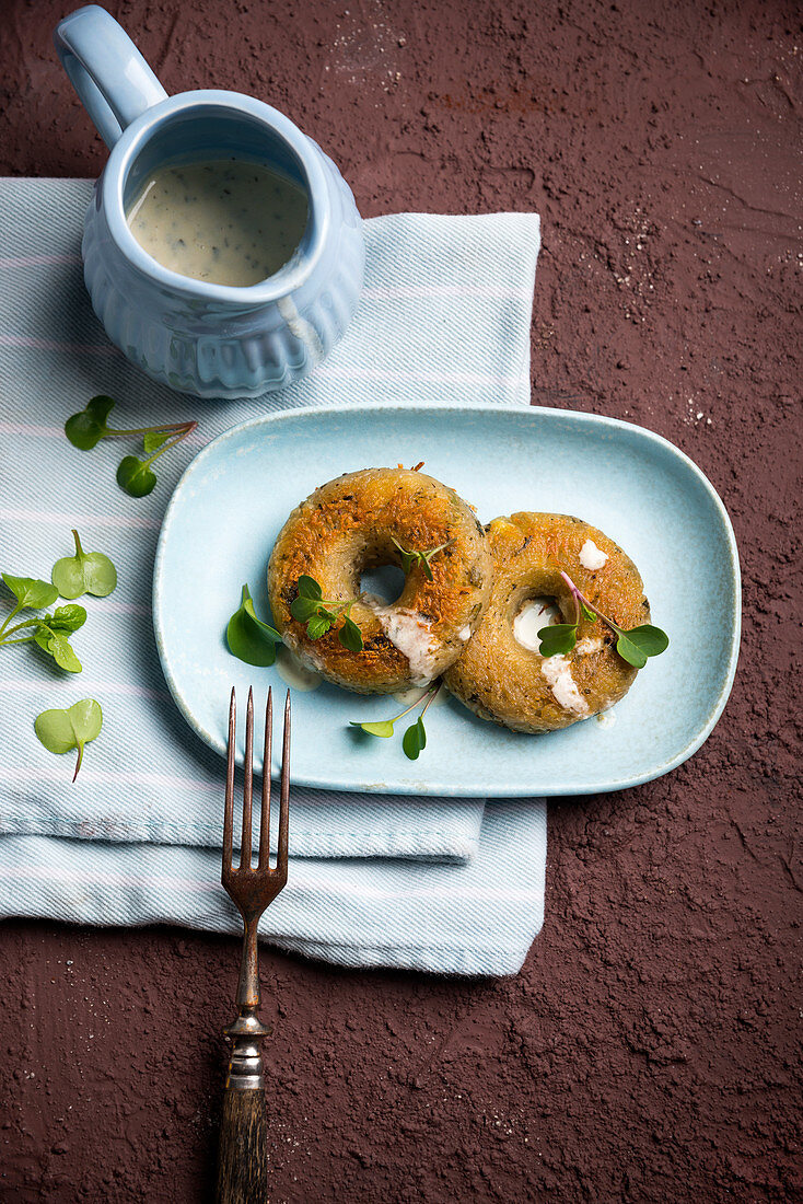 Savoury potato doughnuts with a herb sauce