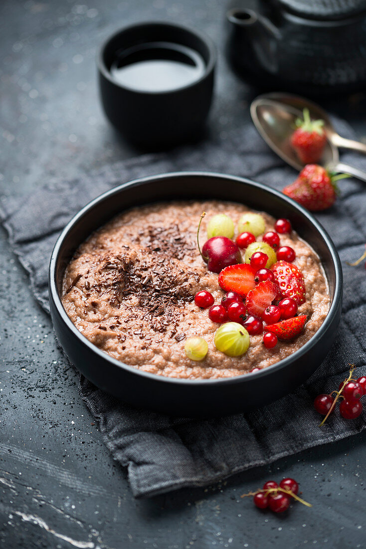 Vegan chocolate millet porridge with fresh fruits