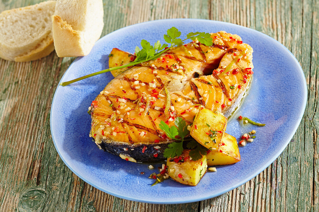 Spicy-marinated, grilled salmon steak with a papaya salad