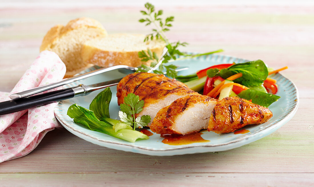 Grilled BBQ chicken breast with a bok choy salad and white bread