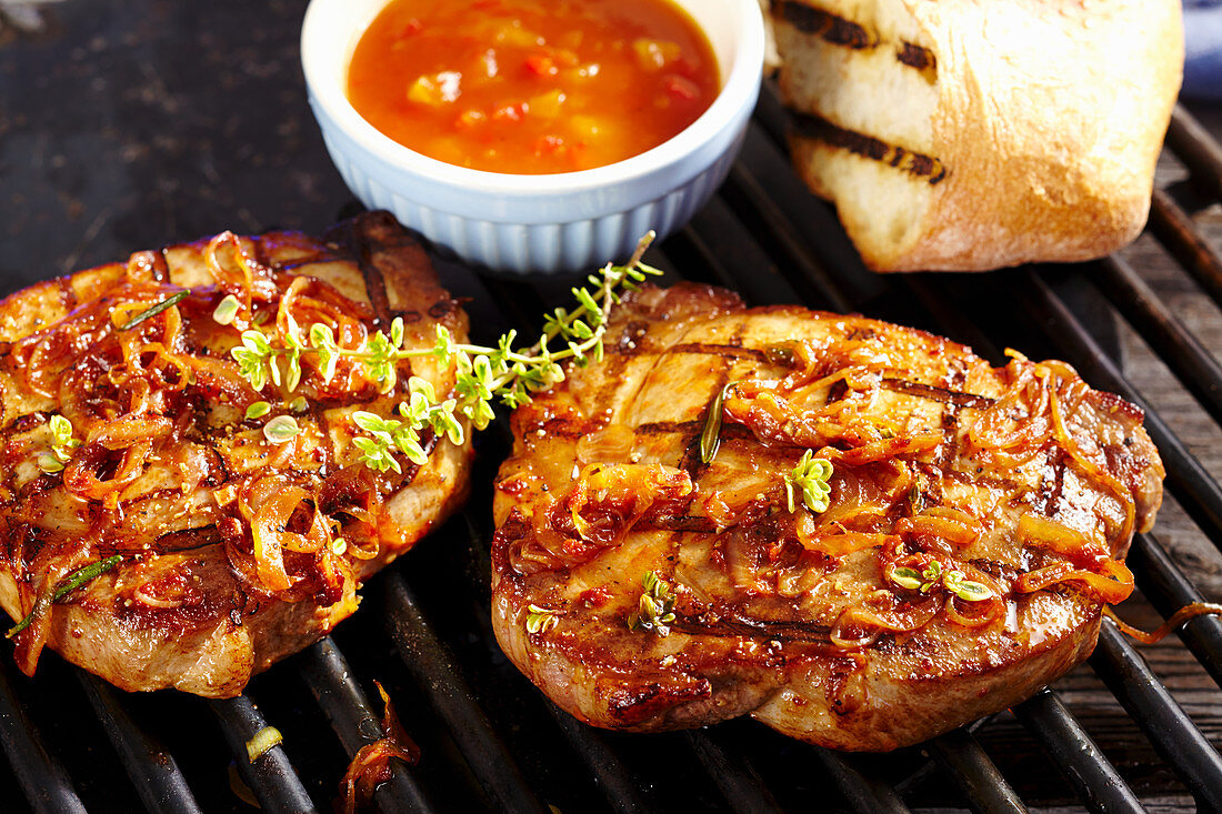 Grilled marinated collar steaks with tomato relish and white bread