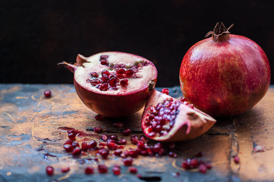 Pomegranates, whole and sliced open