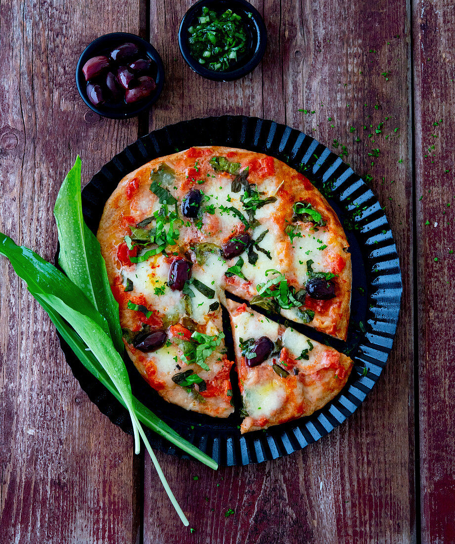 Pizza with olives and wild garlic