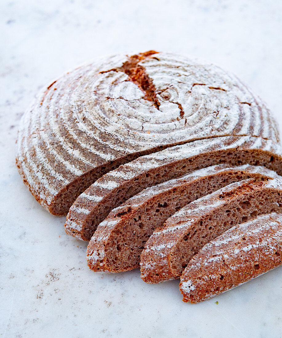A round loaf of wholemeal bread, sliced