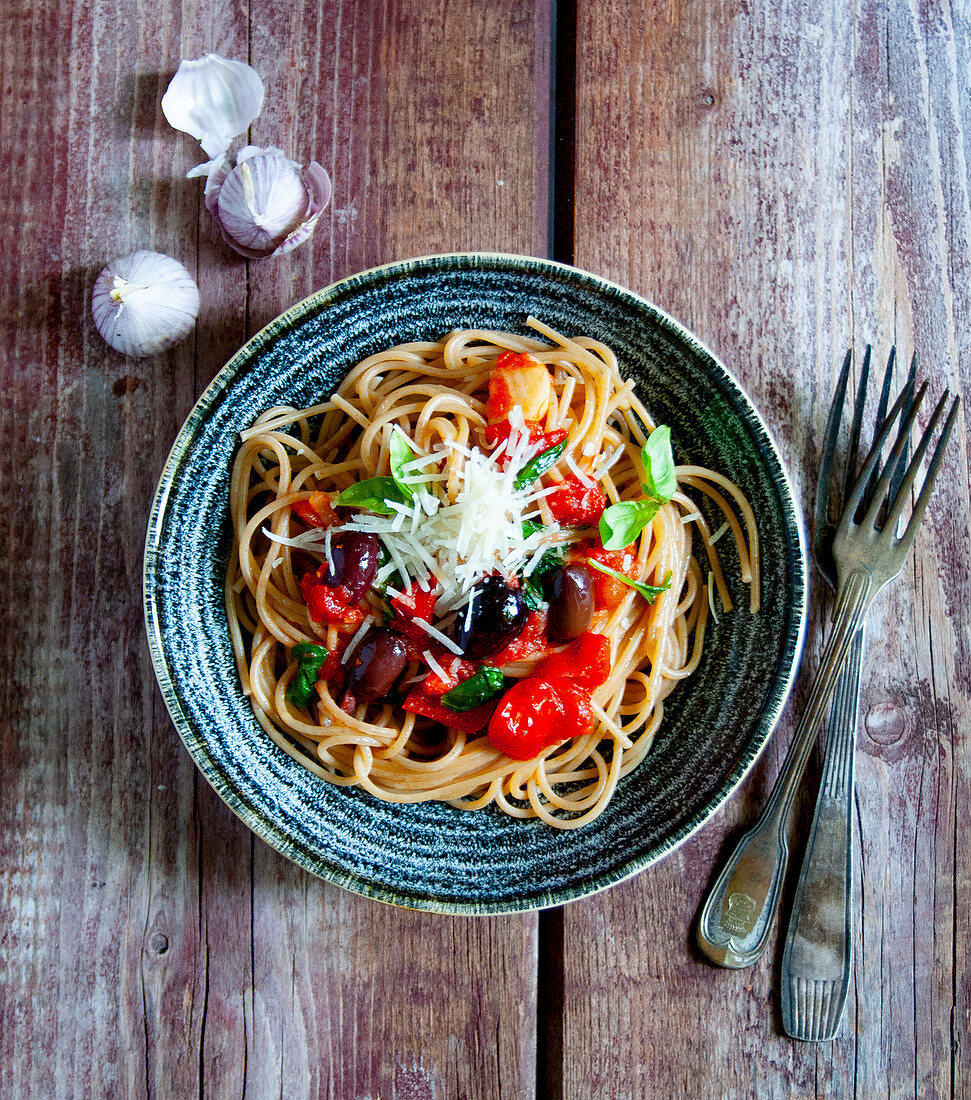 Spaghetti with a tomato and basil sacue and olives