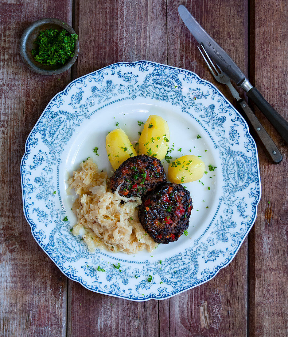 Black pudding and rice meatballs with sauerkraut and parsley potatoes