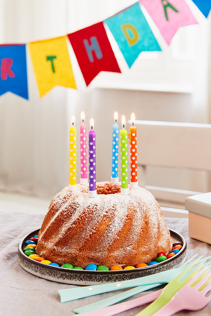 A lemon Bundt cake with candles for a birthday