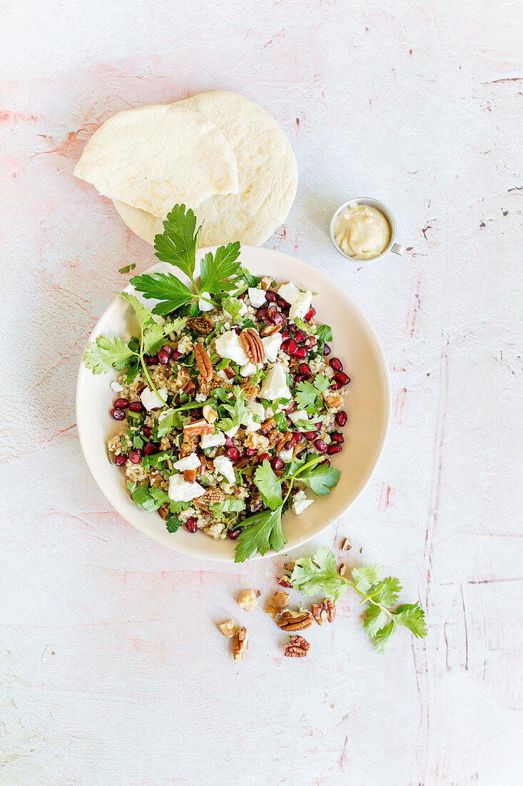Bulgur salad with pecan nuts, pomegranate seeds and figs