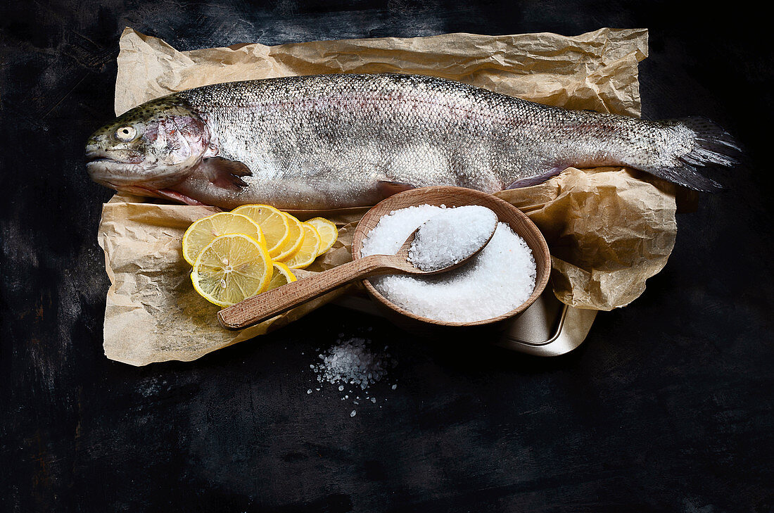 Whole fresh salmon trout with salt and lemon