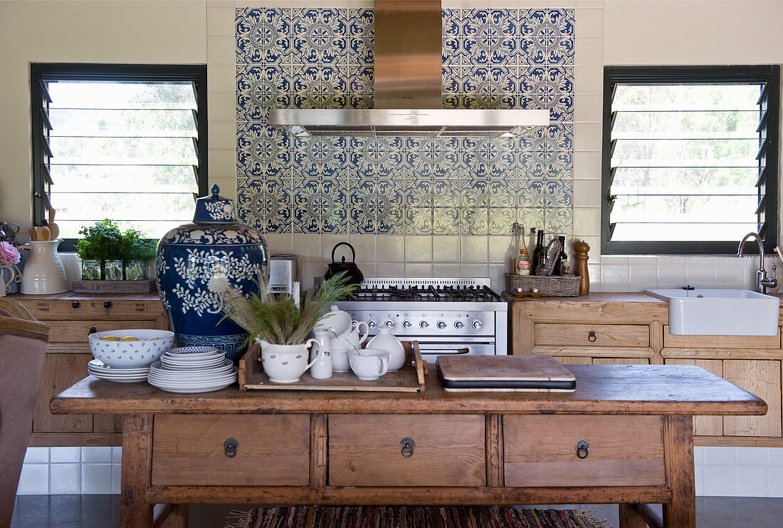 Crockery on wooden kitchen table with drawers