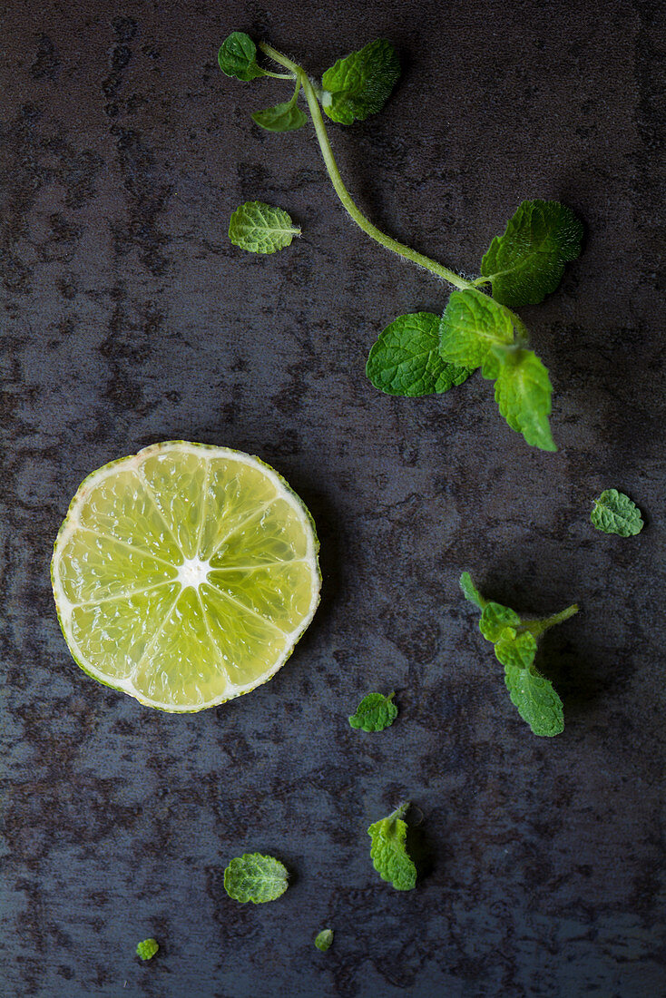 A slice of lime and mint leaves