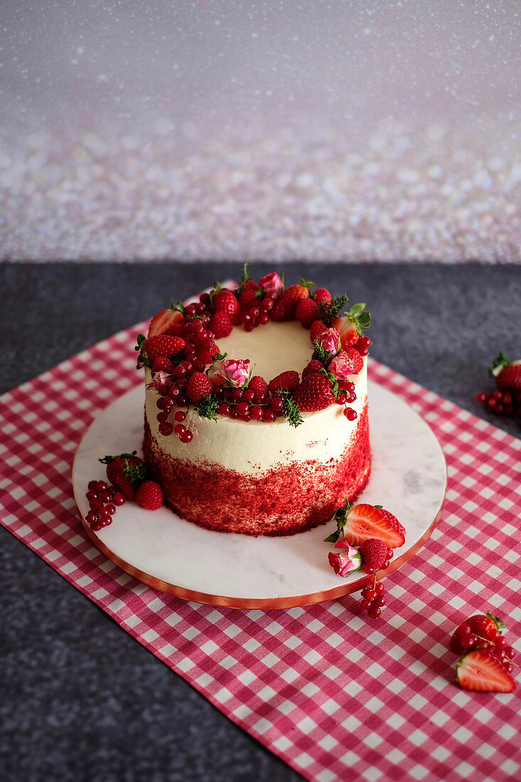 A red velvet cake with fresh berries