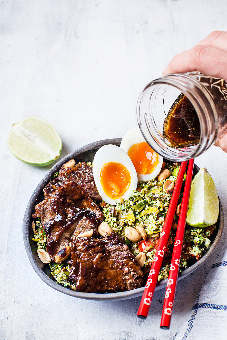 Thai style broccoli 'rice' with spicy dressing, eggs, and beef