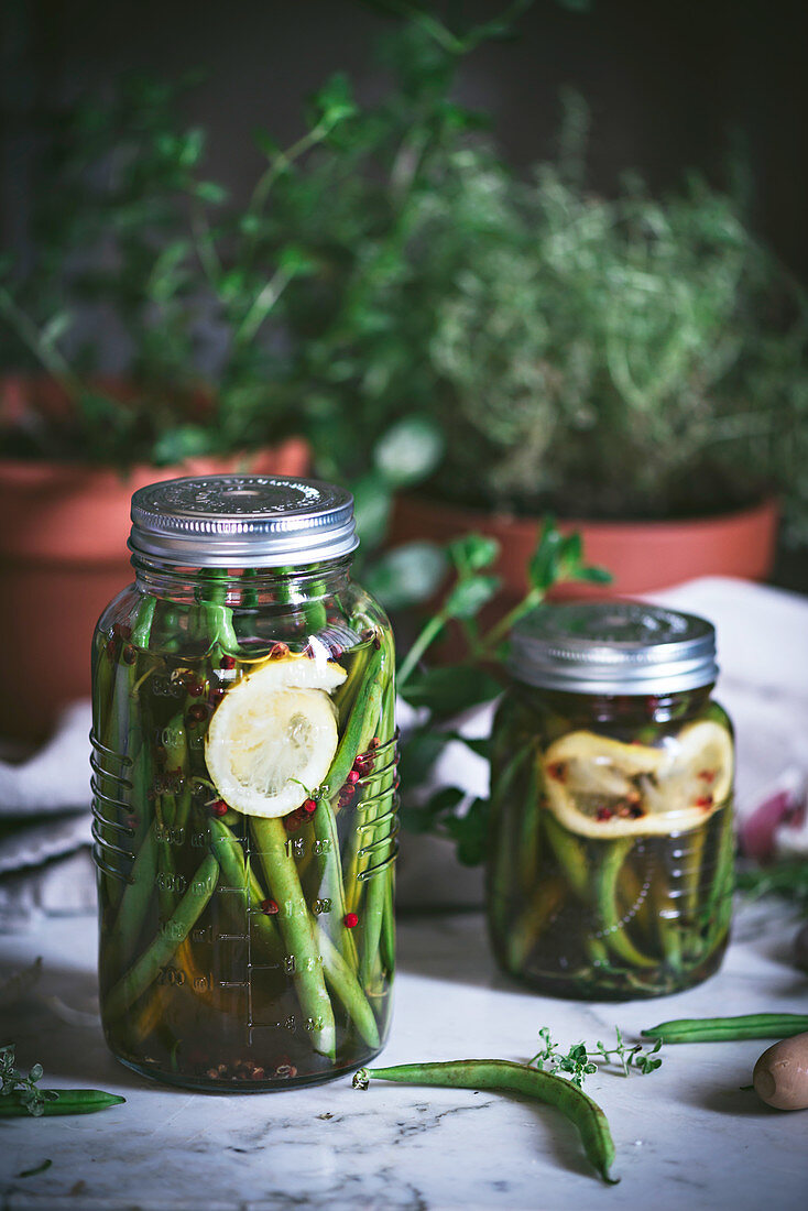 Marinated green beans and flesh lemon arranged on rustic table