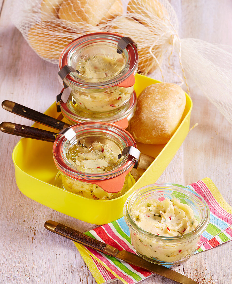 Homemade chilli butter in small preserving jars to take away