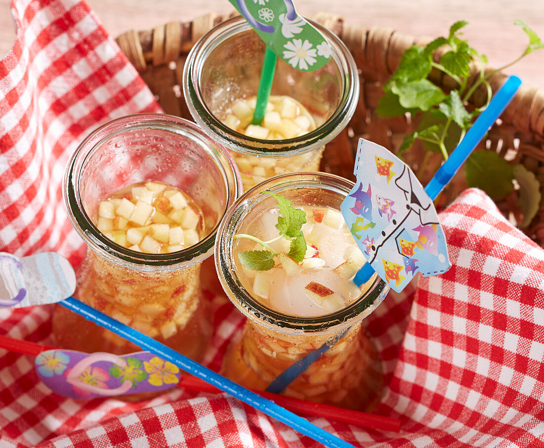 Apple and vanilla iced tea in a basket for a picnic