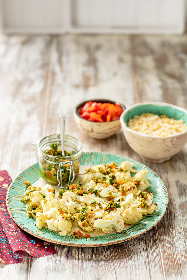 Baked cauliflower with olives salsa and couscous