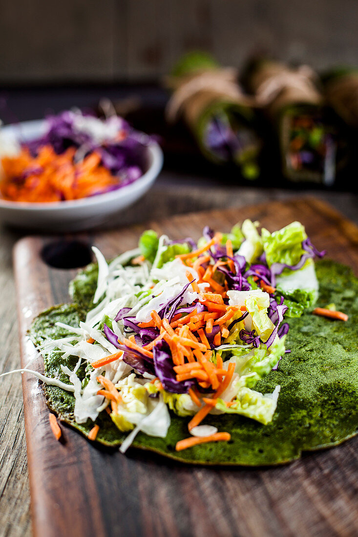 A gluten-free salad burrito being made