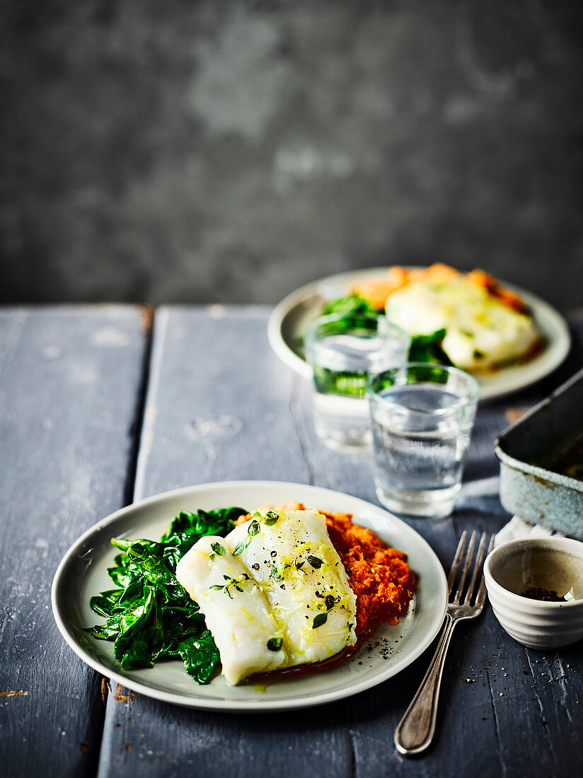 Herb and garlic baked cod with romesco sauce and spinach
