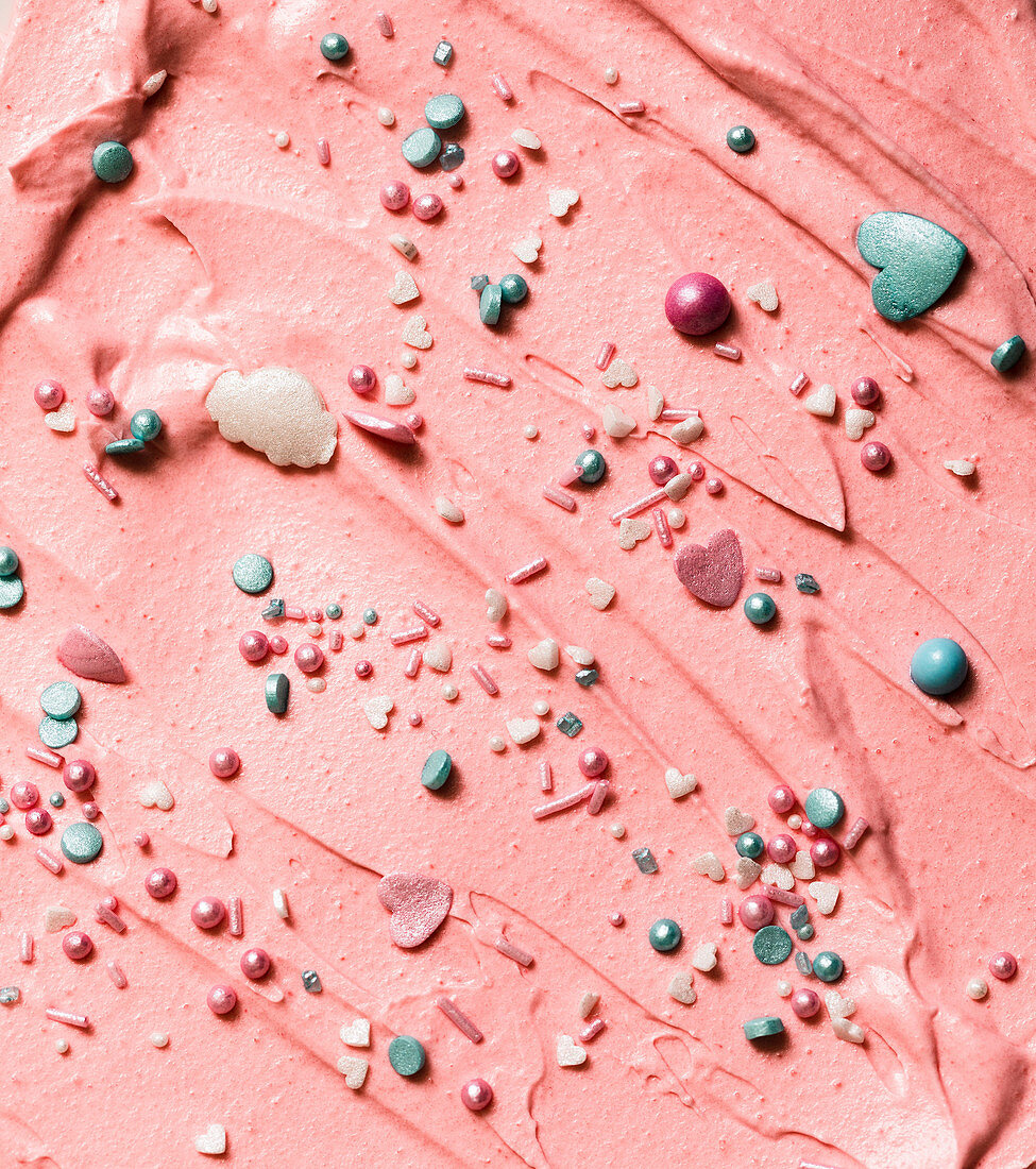 Pink buttercream with coloured pearls and hearts