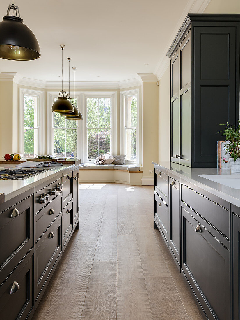 Island counter in elegant kitchen with bay window