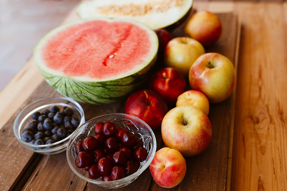 Delicious summer fruits on wooden table