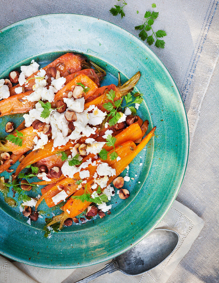 Roasted carrot with feta cheese on plate