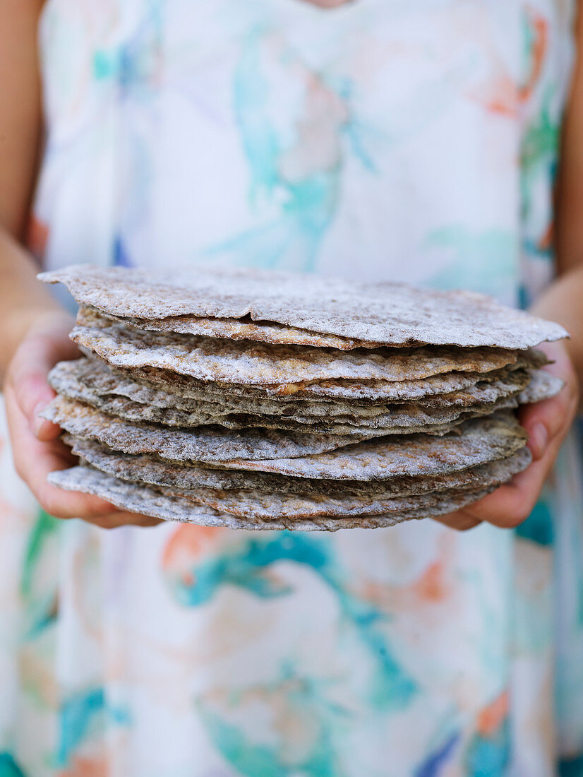Woman holding flat breads