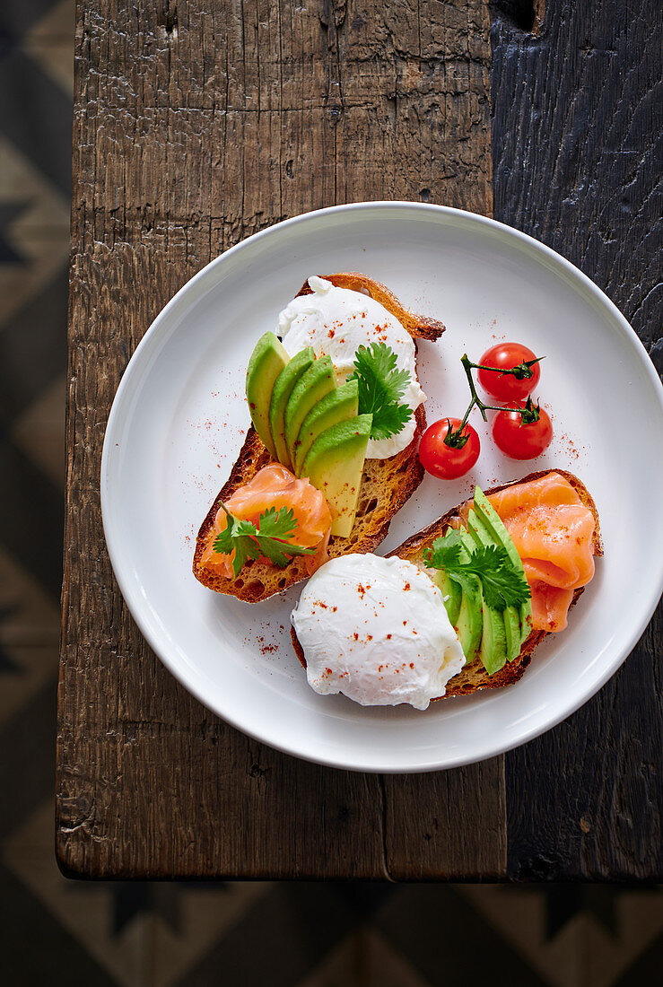 Salmon and avocado on toast with a poached egg