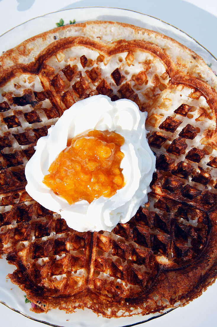 Waffles with cream and cloudberry jam