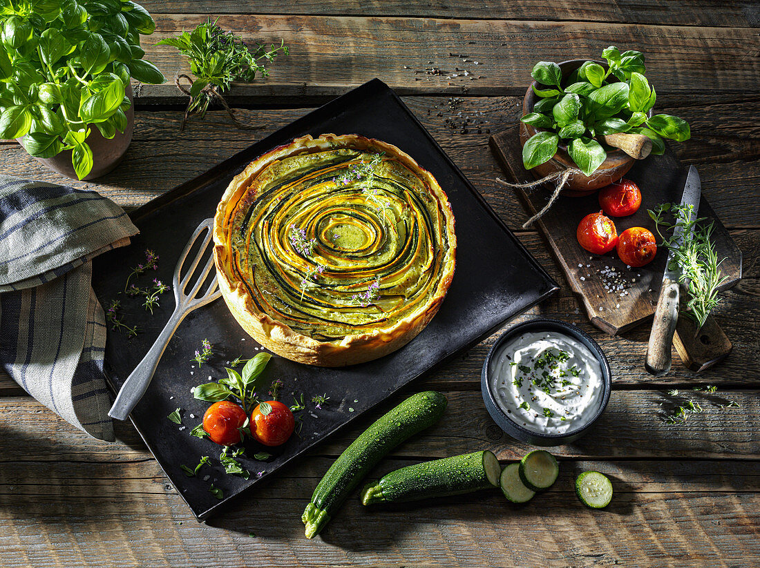 Yellow-green zucchini bread on a baking sheet, with stewed tomatoes