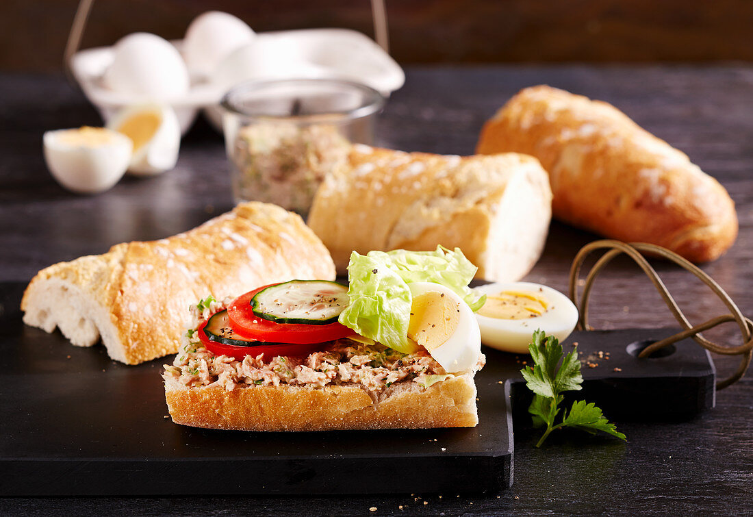 Baguette with tuna niscoise salad, tomato, cucumber, mayonnaise, eggs, mustard and lettuce leaf