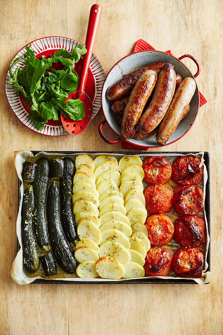 Italian flag made of roasted vegetables, served with sausages