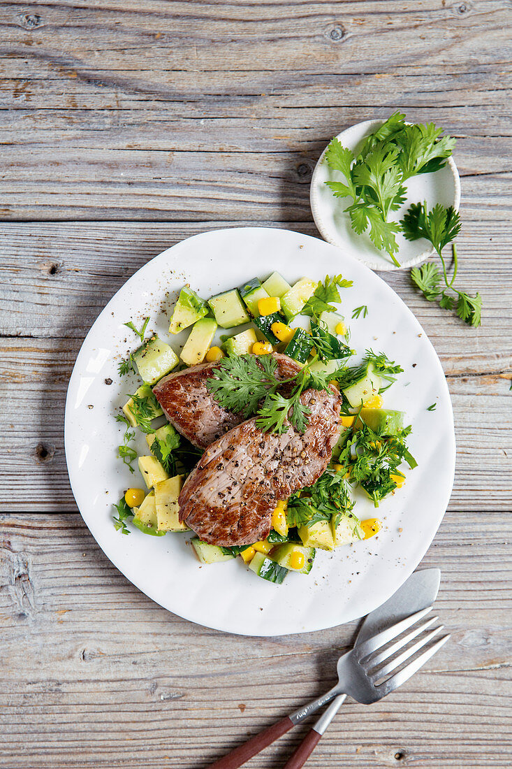 Beef steaks with avocado and cucumber salsa