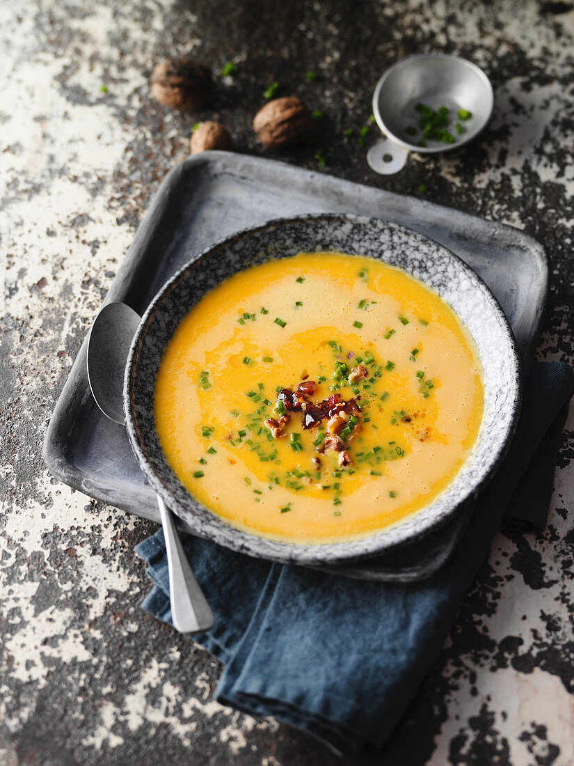 Sweet potato soup with smoked ham and walnuts