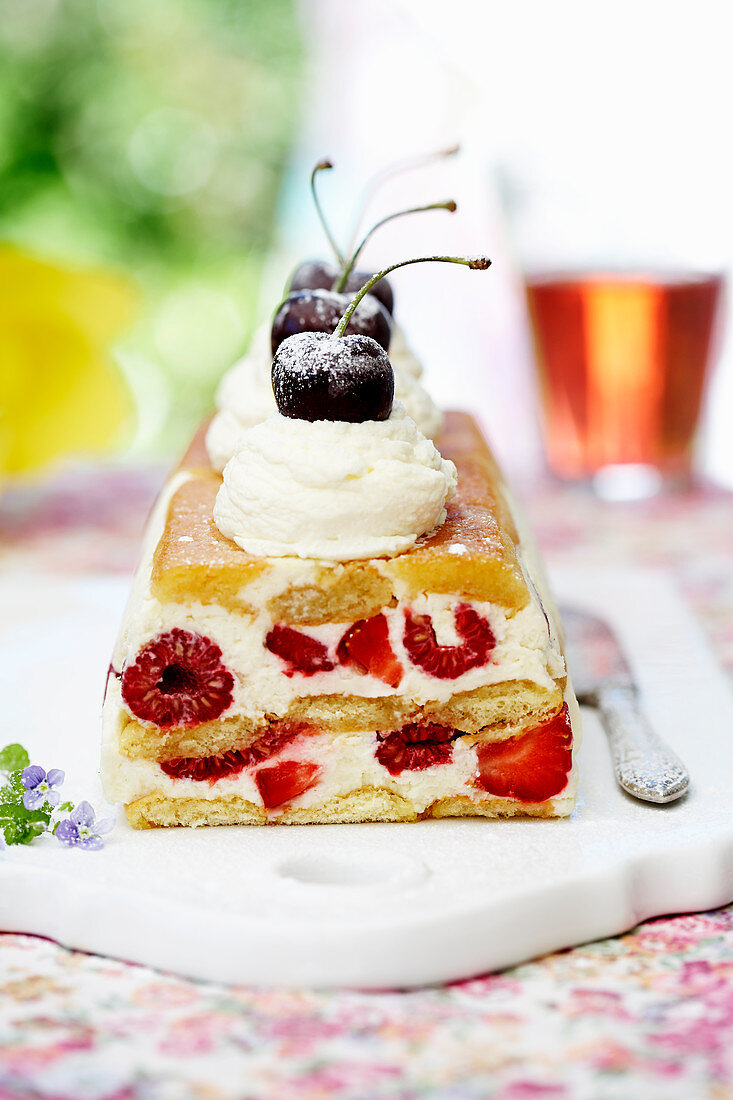 Berry cake with cream and cherries