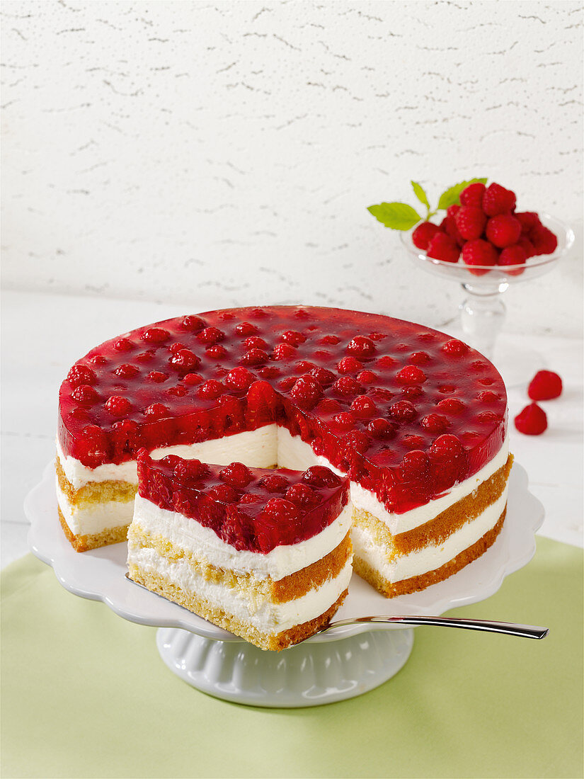 A cheesecake with fresh raspberries