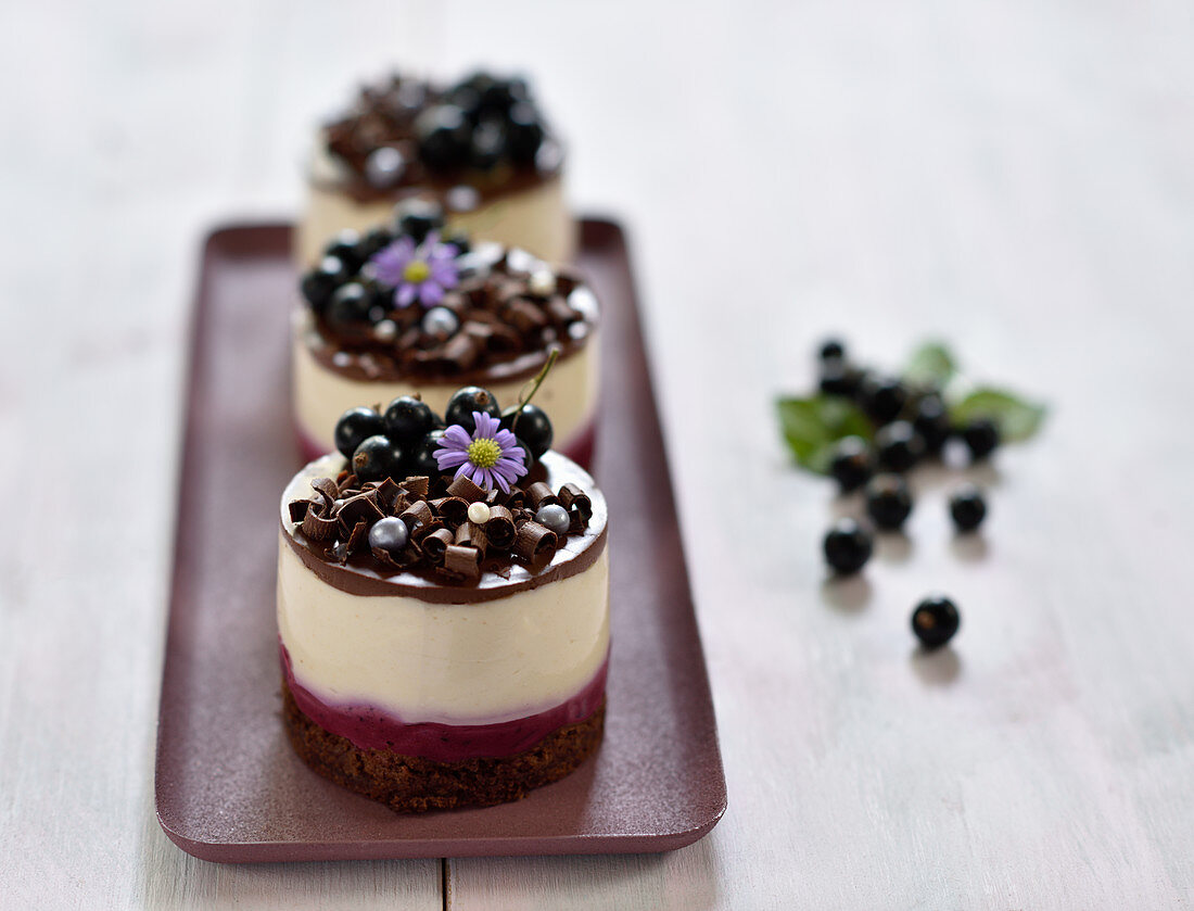 M&S British Blackcurrant & Elderflower Mousse Cake on decorative hearts  plate set on purple background Stock Photo - Alamy