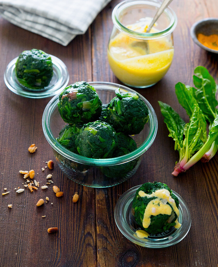 Spinach balls with hollandaise and pine nuts