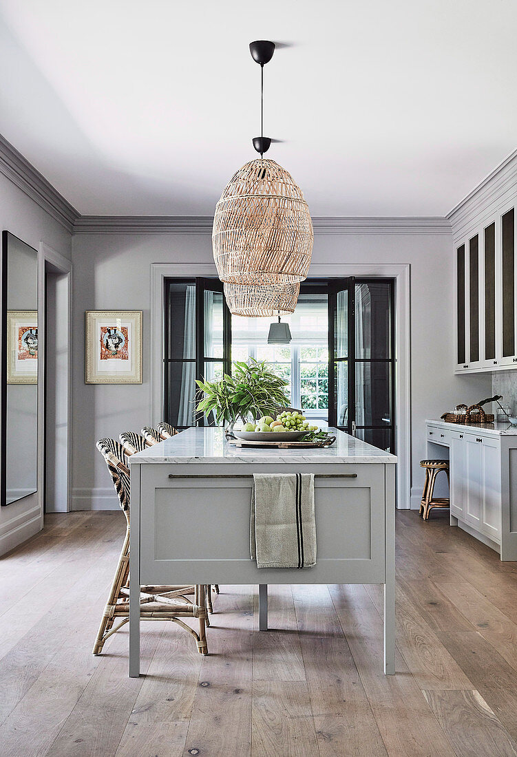 Bar stool at the kitchen island in a classic kitchen in grey